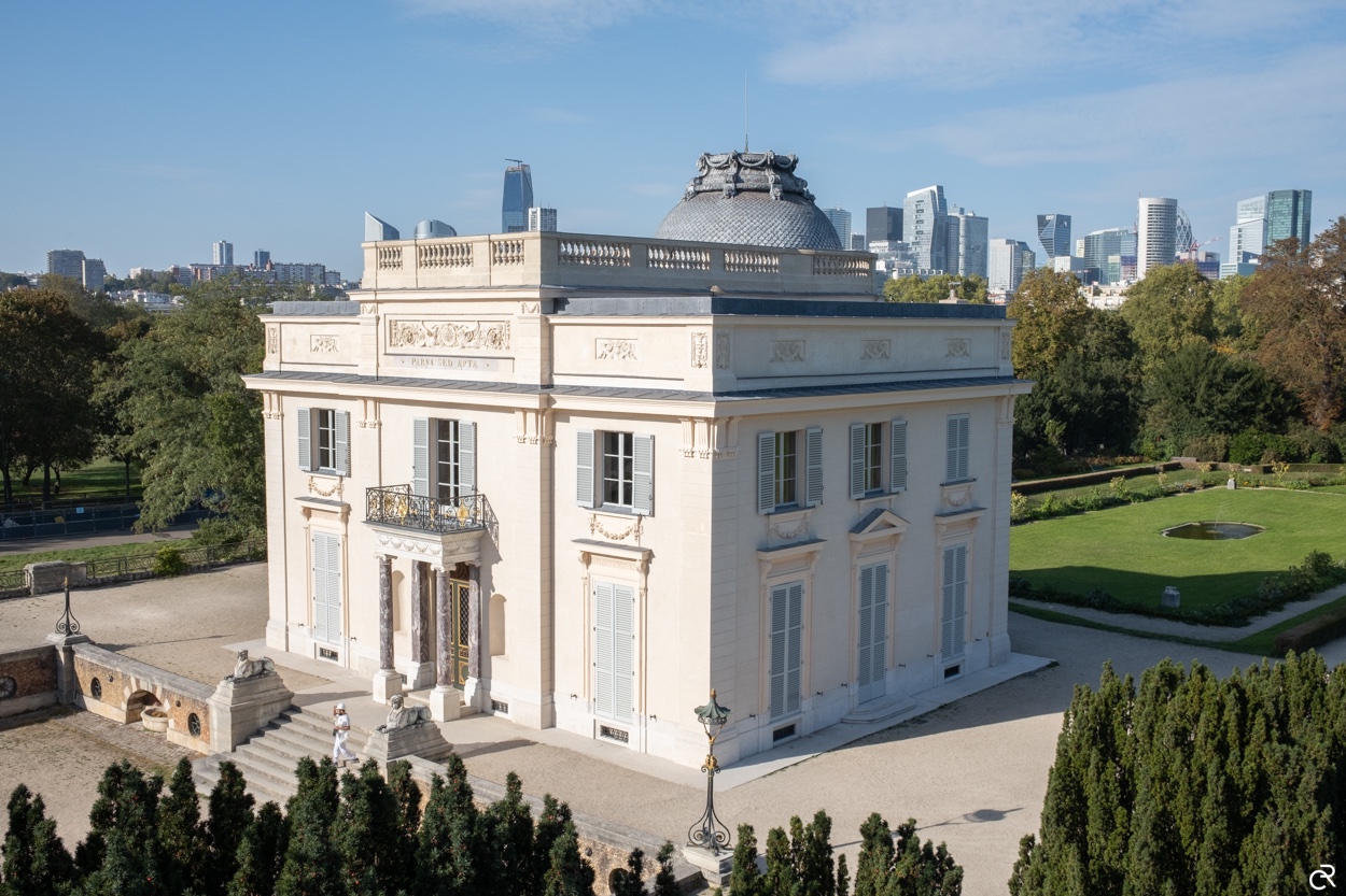 French limestone architecture with domed roof and formal garden
